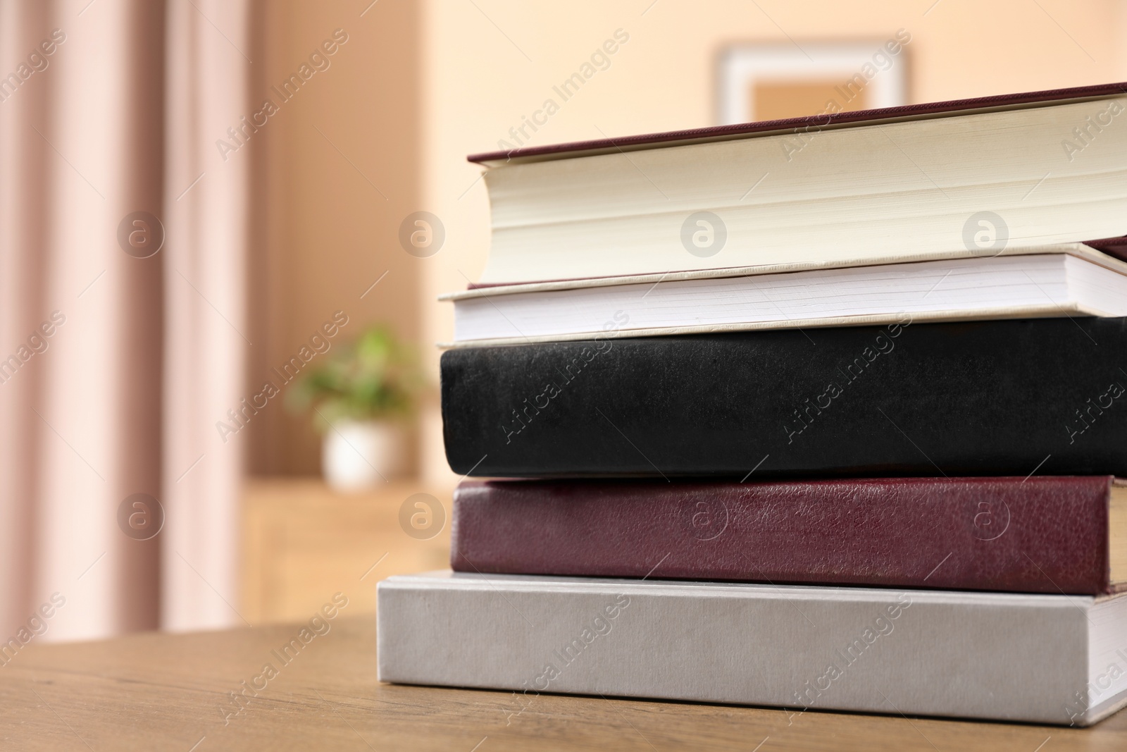 Photo of Books on wooden table indoors, closeup. Space for text