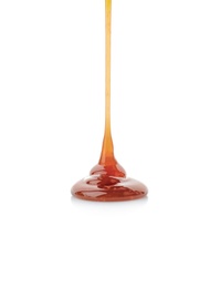 Photo of Pouring caramel sauce onto white background