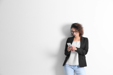 Photo of Beautiful woman using phone on white background