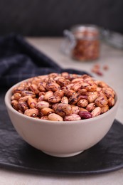 Photo of Bowl with dry kidney beans on table, closeup