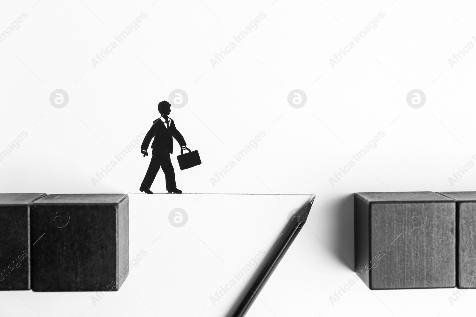 Photo of Drawing line with pencil between wooden cubes to help businessman figure cross bridge on white background, flat lay. Connection, relationships, support and deal concepts