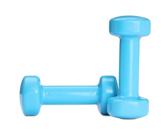 Photo of Light blue dumbbells isolated on white. Sports equipment