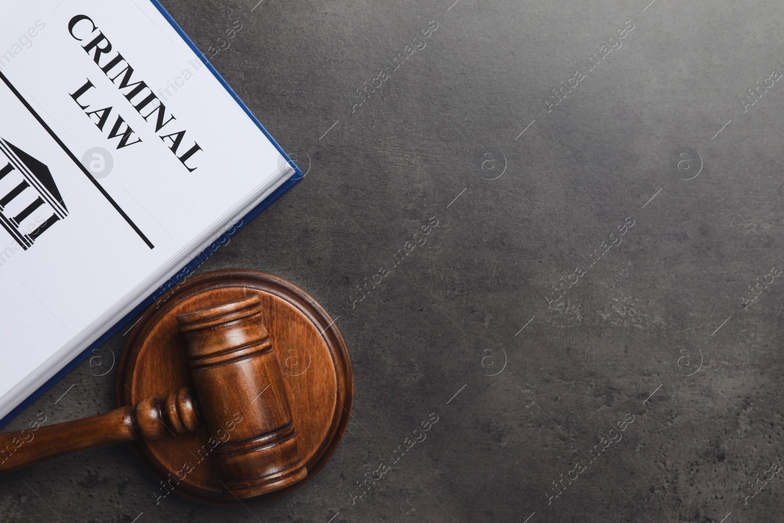 Photo of Judge's gavel and Criminal law book on grey background, flat lay. Space for text