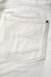 White jeans with pocket as background, top view