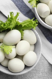 Photo of Peeled boiled quail eggs on grey table, flat lay