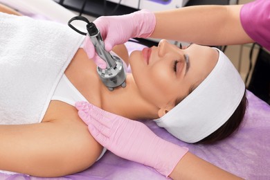 Young woman undergoing cosmetic procedure in beauty salon. Microcurrent therapy