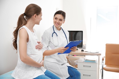 Pregnant woman having appointment at gynecologist office