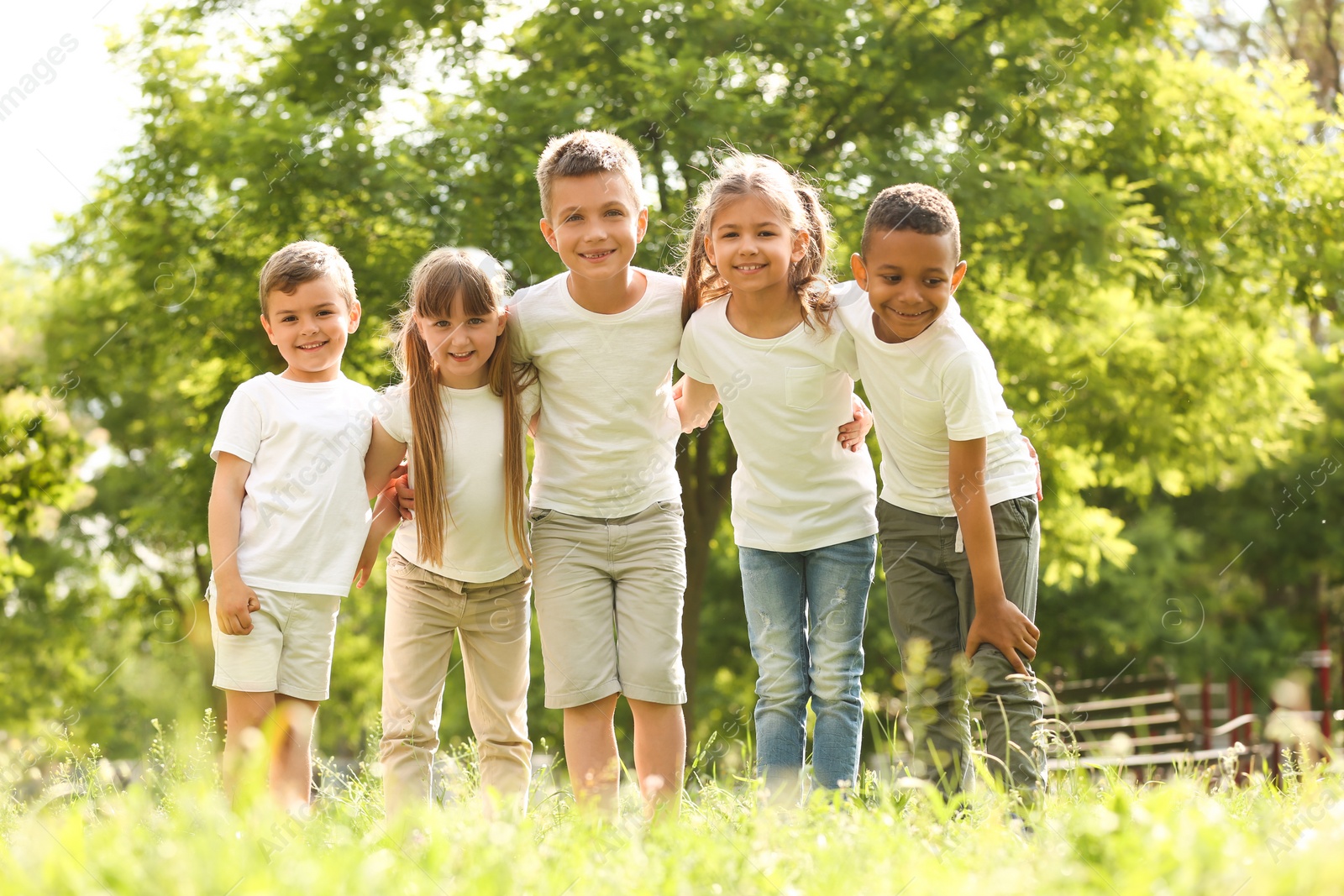 Photo of Group of children huddling in park. Volunteer project