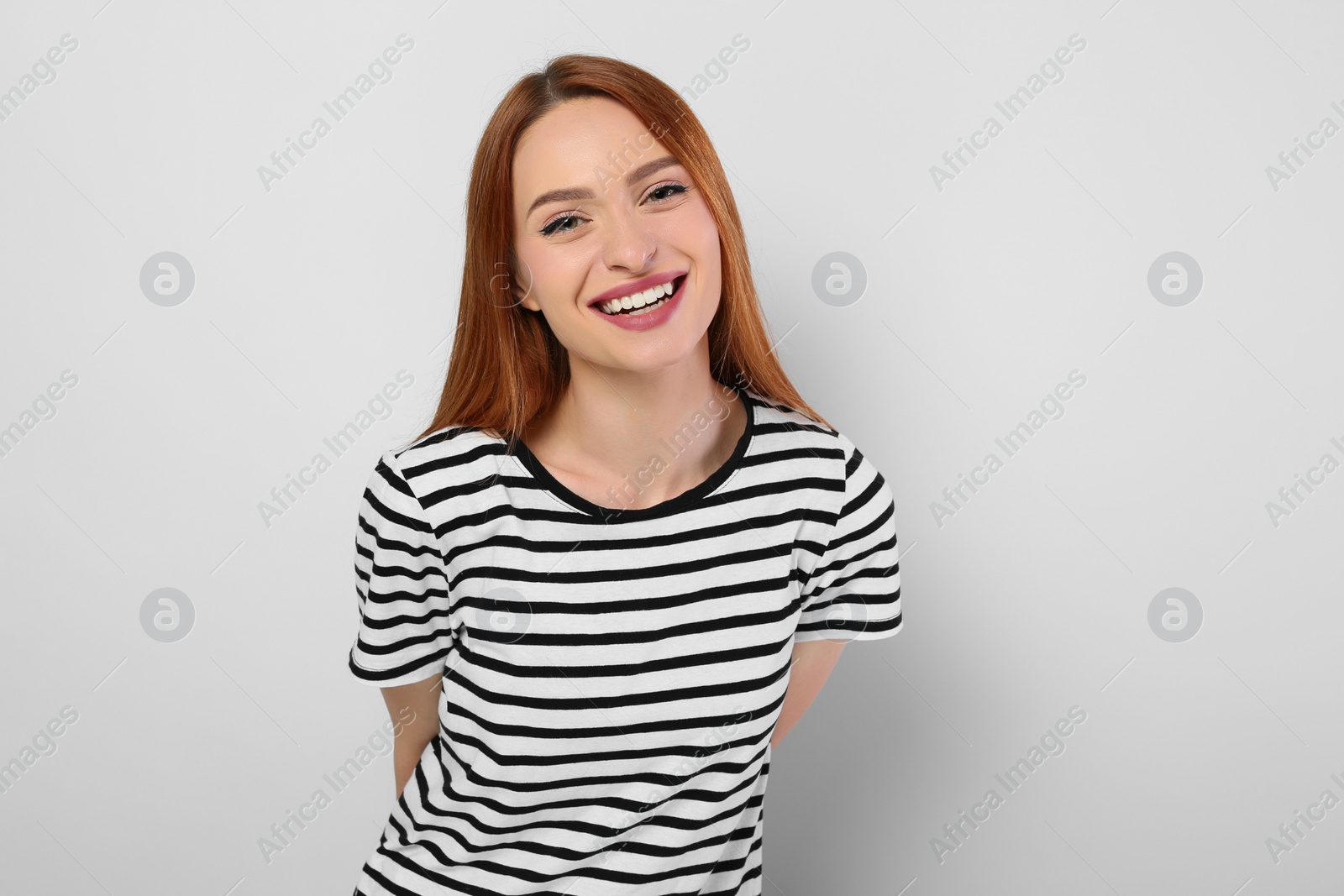 Photo of Portrait of beautiful young woman on light gray background