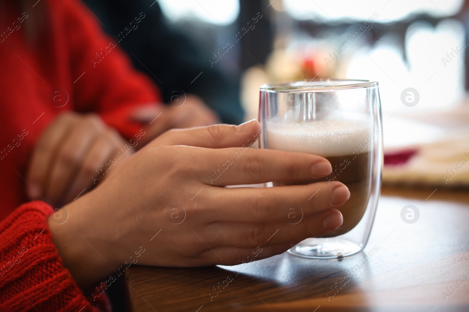 Photo of Lovely couple with fresh aromatic coffee at table in cafe, closeup