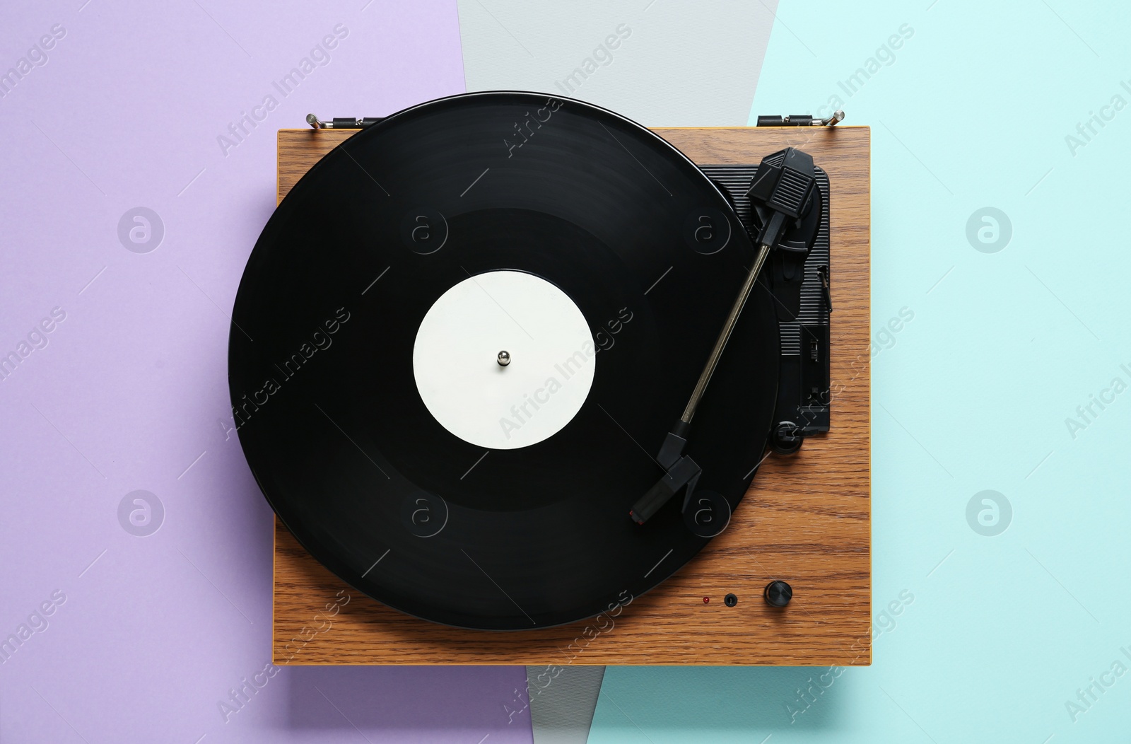 Photo of Turntable with vinyl record on color background, top view