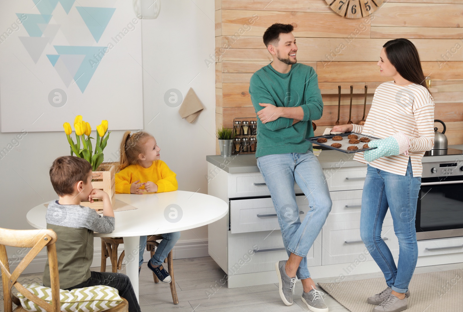 Photo of Woman treating her family with oven baked cookies at home