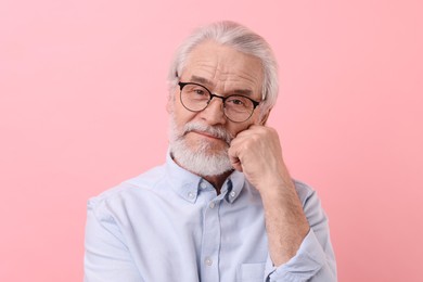 Photo of Portrait of stylish grandpa with glasses on pink background