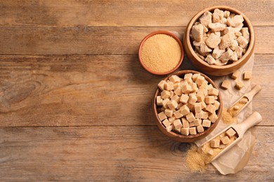 Different types of sugar on wooden table, flat lay. Space for text