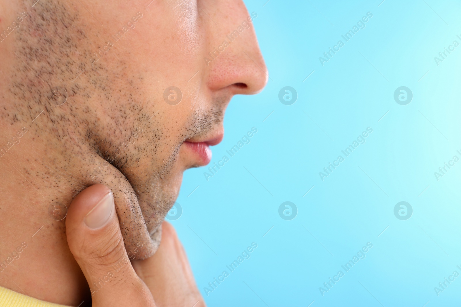 Photo of Young man with double chin on blue background, closeup. Space for text
