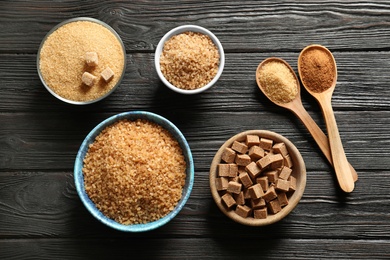 Flat lay composition with brown sugar on wooden table