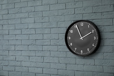 Modern clock on brick wall. Time concept