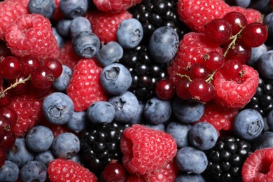 Assortment of fresh ripe berries as background, top view