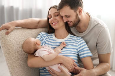 Photo of Happy family. Parents with their cute baby at home