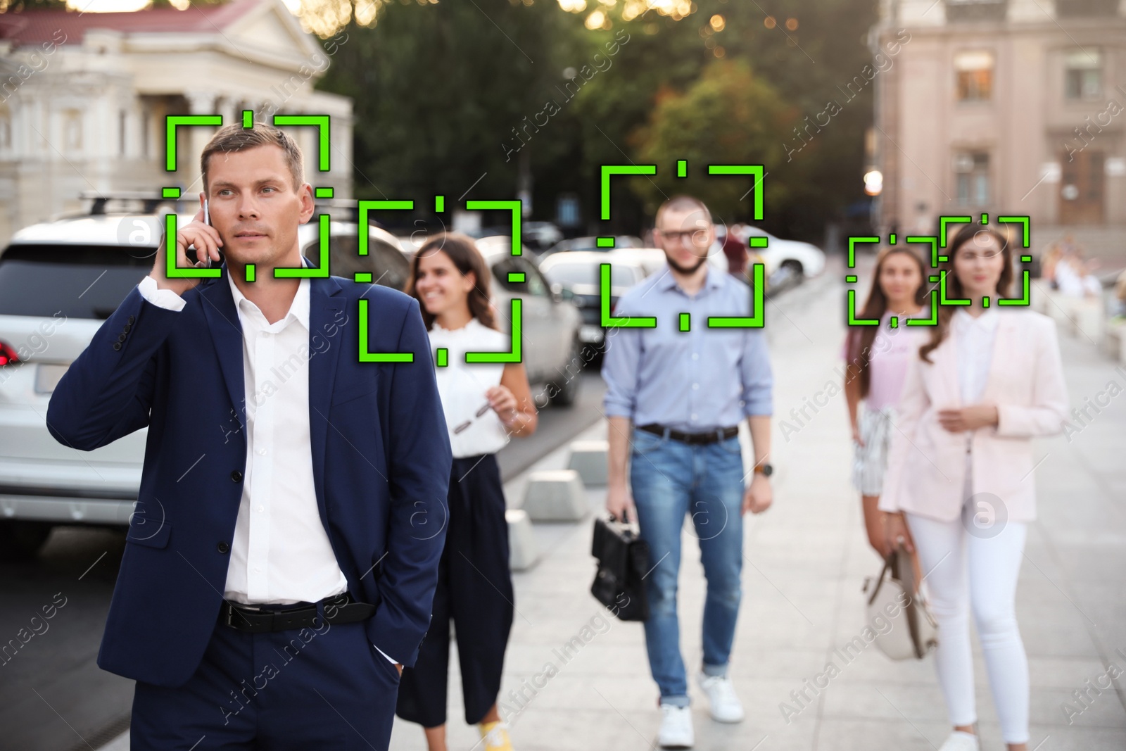 Image of Facial recognition system identifying people on city street 