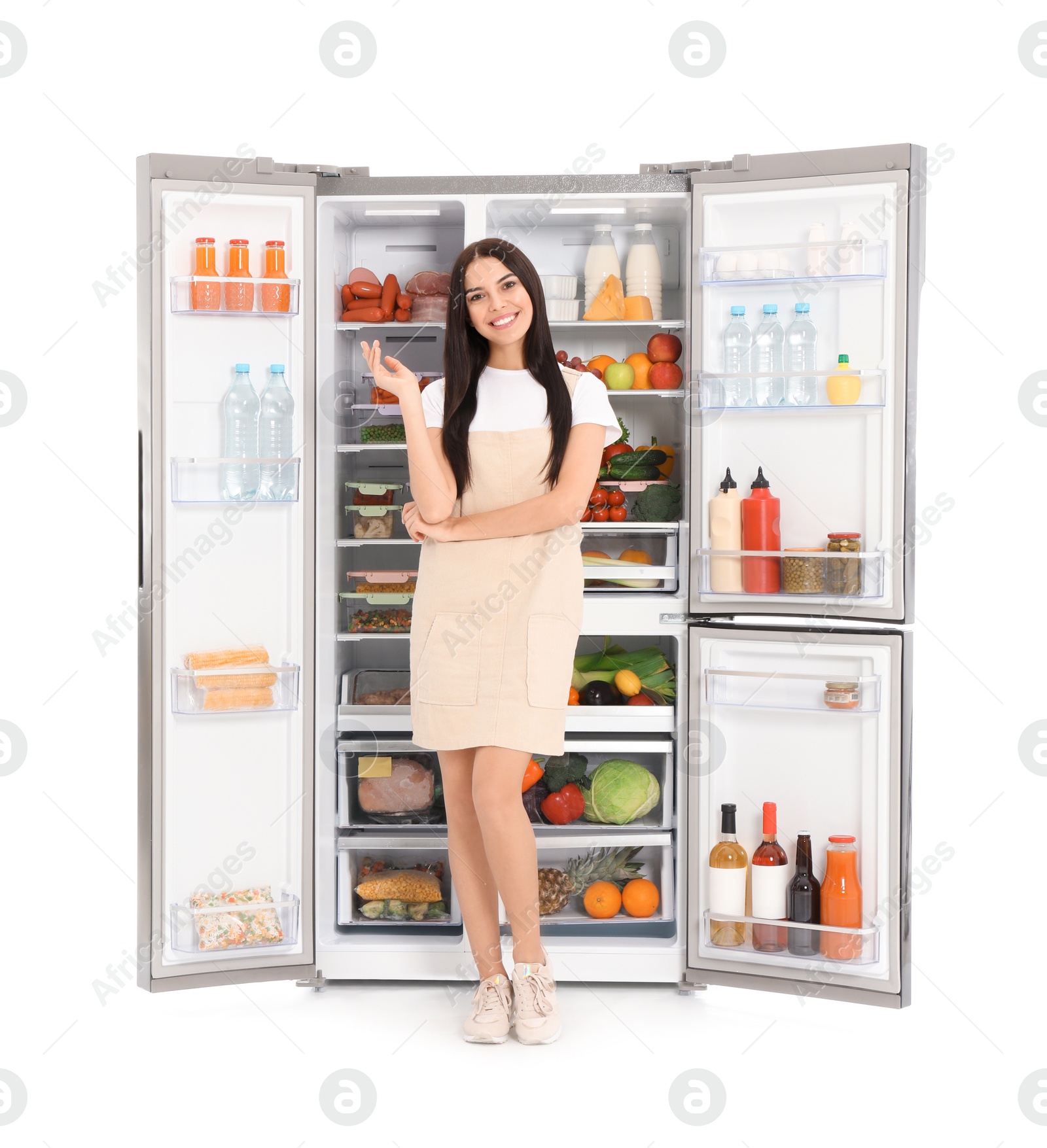 Photo of Young woman near open refrigerator on white background