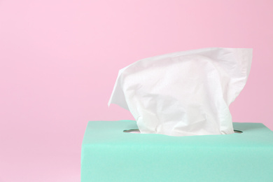 Photo of Box with paper tissues on pink background, closeup