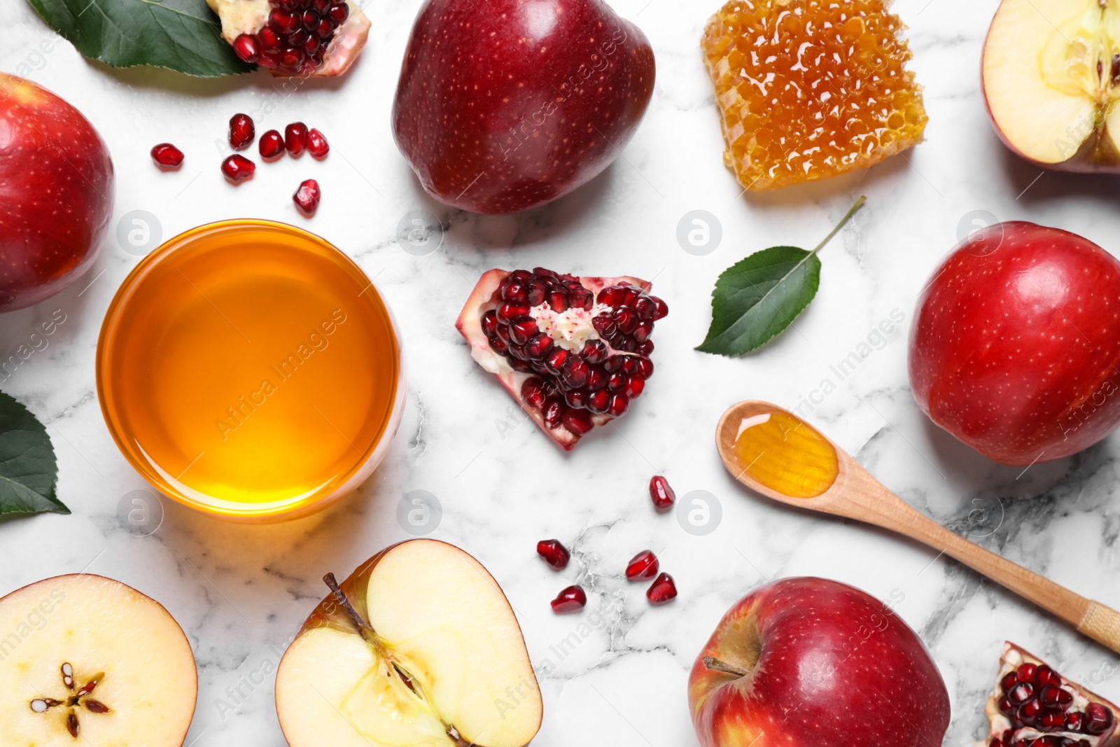 Photo of Honey, apples and pomegranate on white marble table, flat lay. Rosh Hashanah holiday