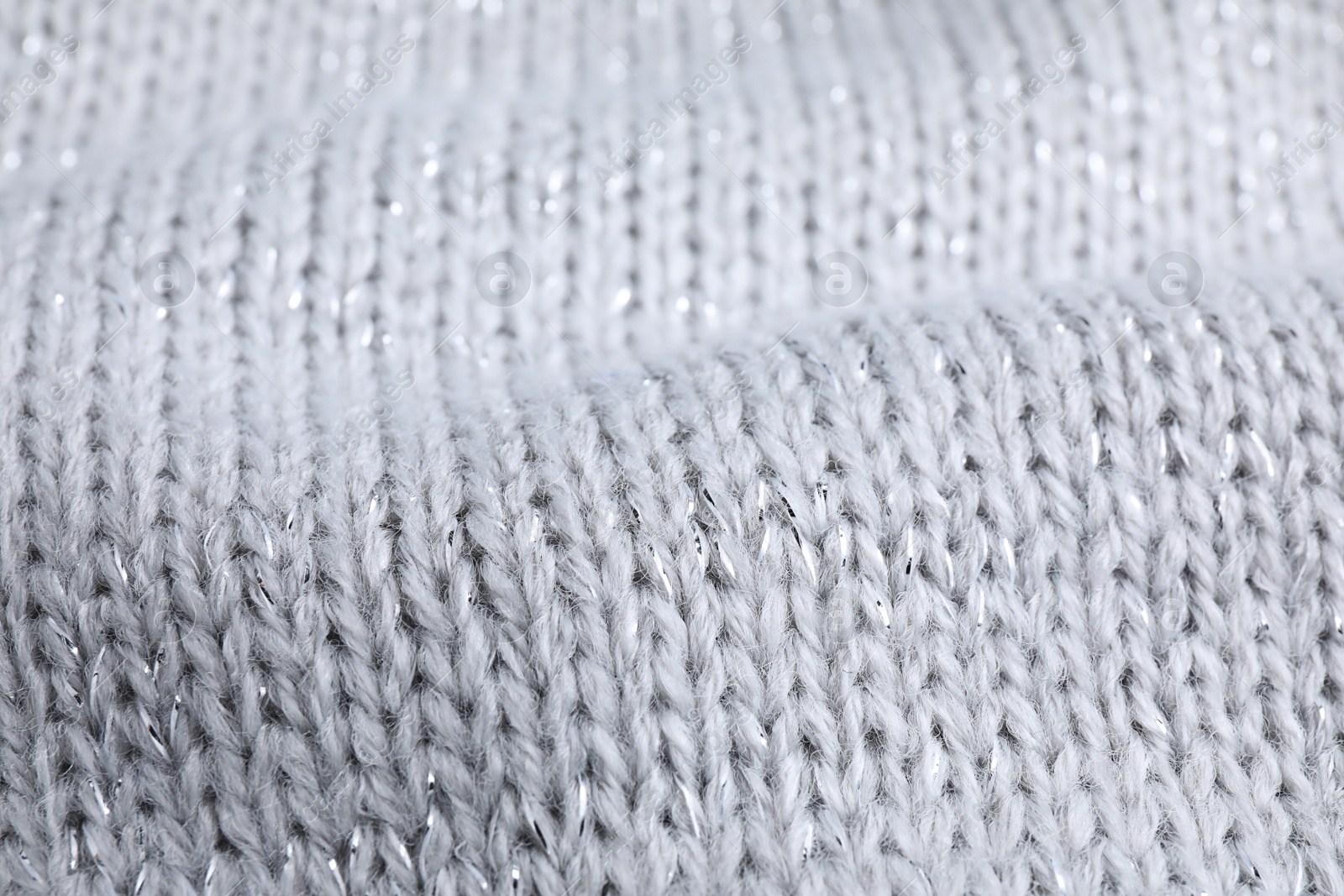 Photo of Warm knitted sweater as background, closeup view