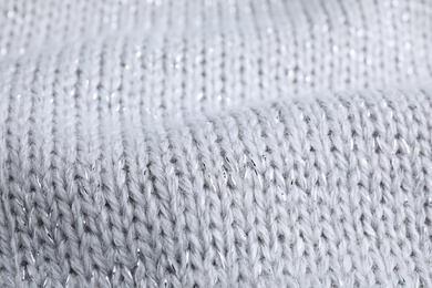 Warm knitted sweater as background, closeup view