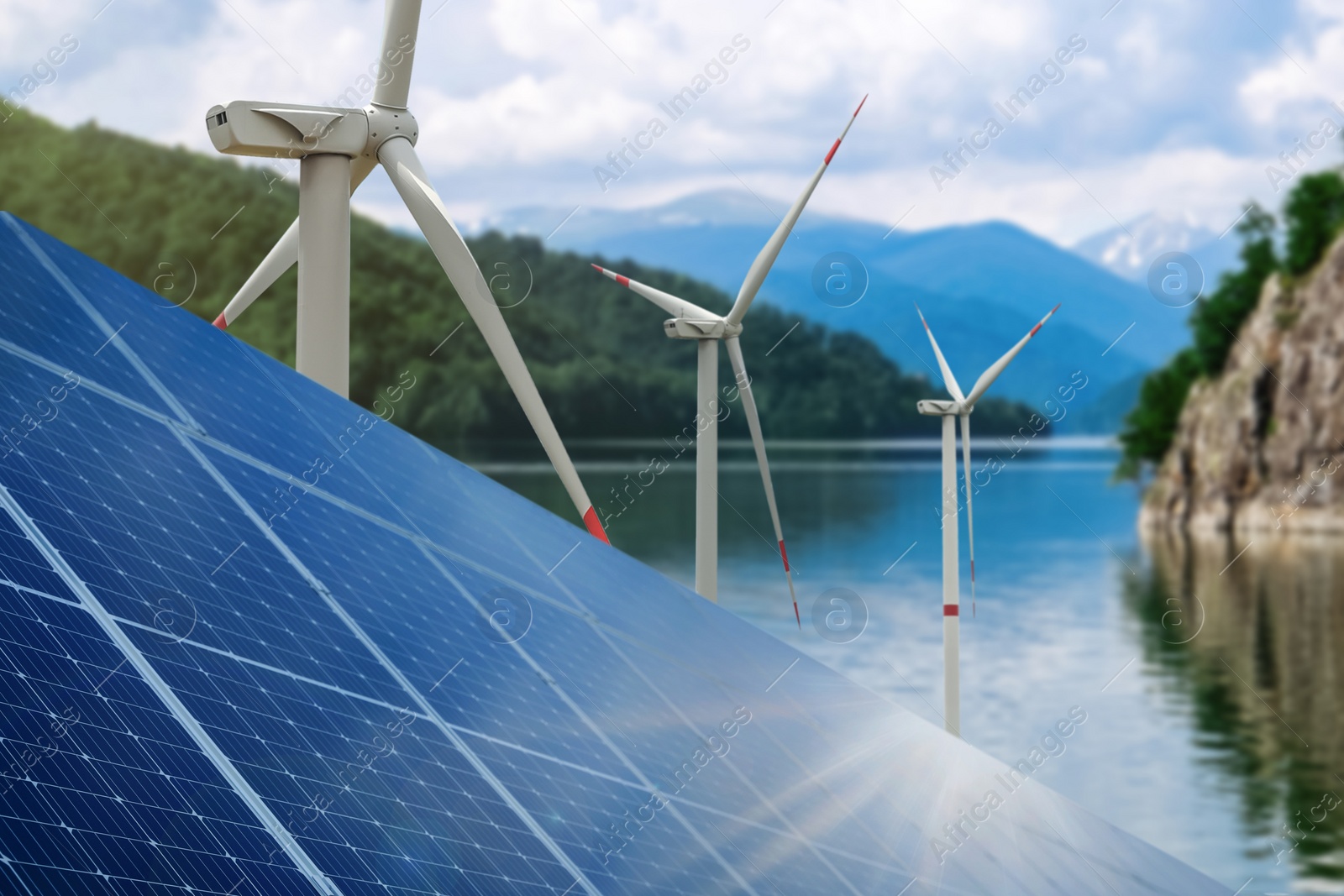 Image of Alternative energy sources. Wind turbines installed in water, solar panels on foreground