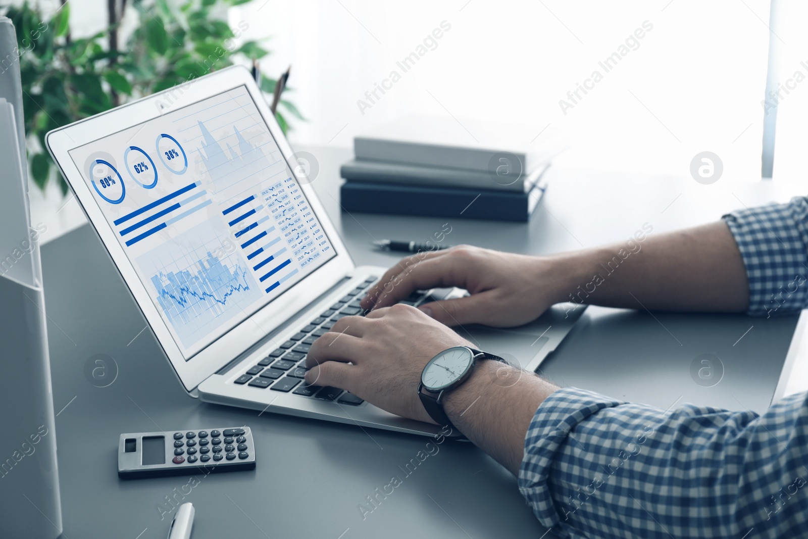 Image of Man working on laptop at table, closeup. Fintech concept