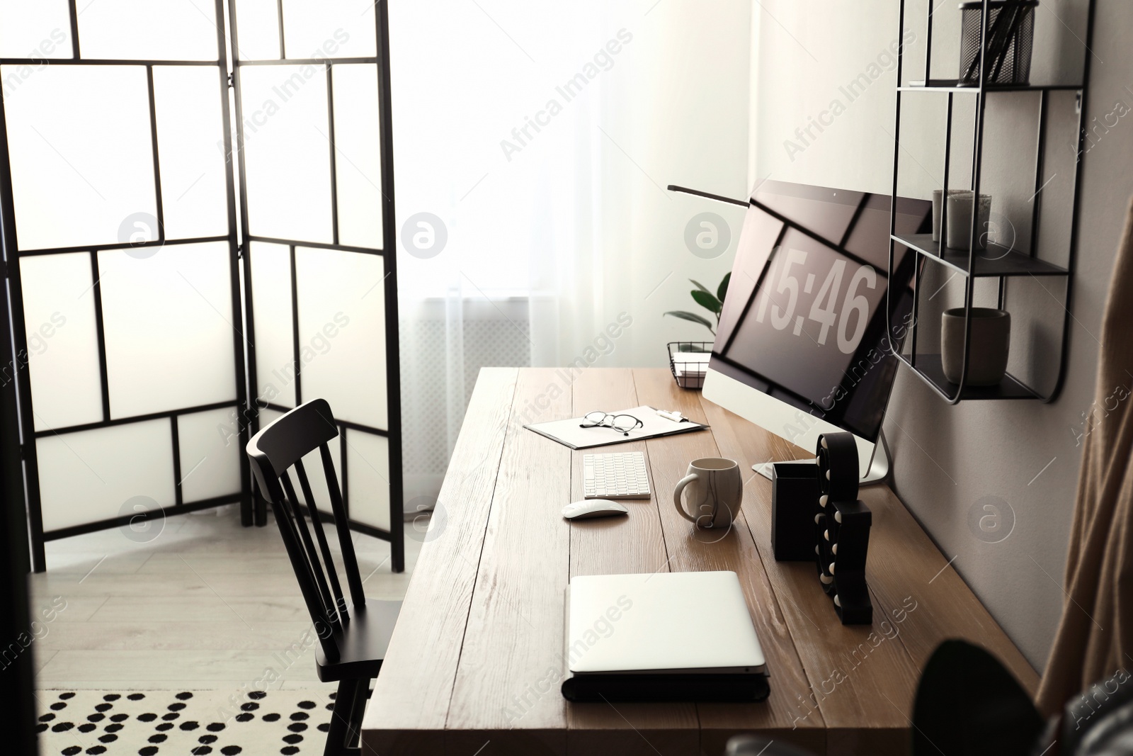 Photo of Modern workplace with computer in room. Interior design