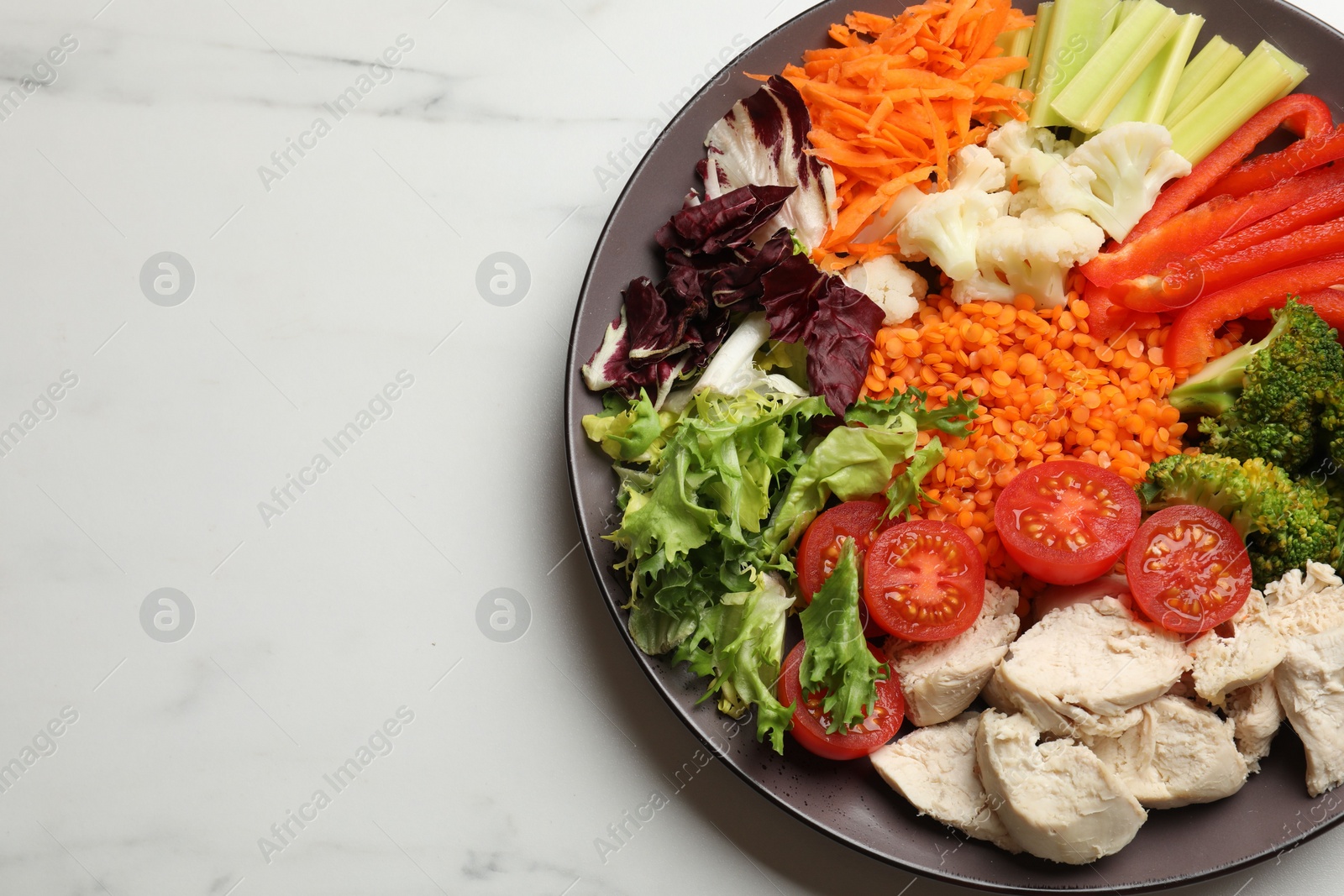 Photo of Balanced diet and healthy foods. Plate with different delicious products on white marble table, top view. Space for text