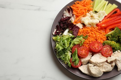 Balanced diet and healthy foods. Plate with different delicious products on white marble table, top view. Space for text