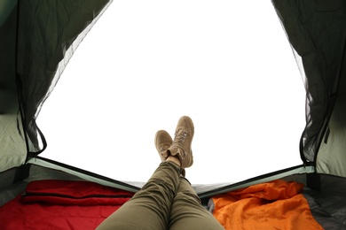 Photo of Closeup of female in camping tent on white background, view from inside