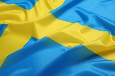 Photo of Flag of Sweden as background, closeup. National symbol