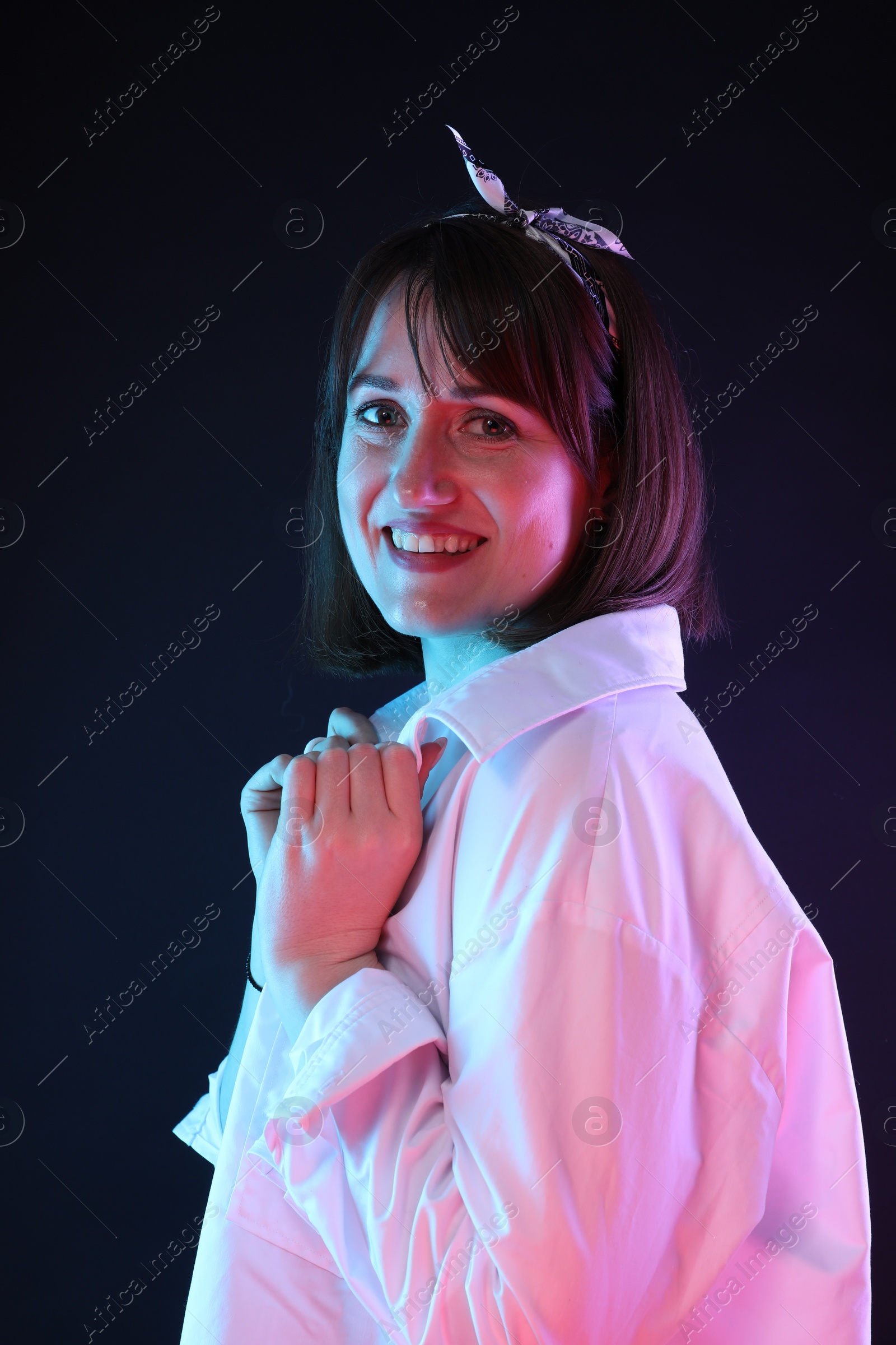 Photo of Portrait of happy woman on dark background