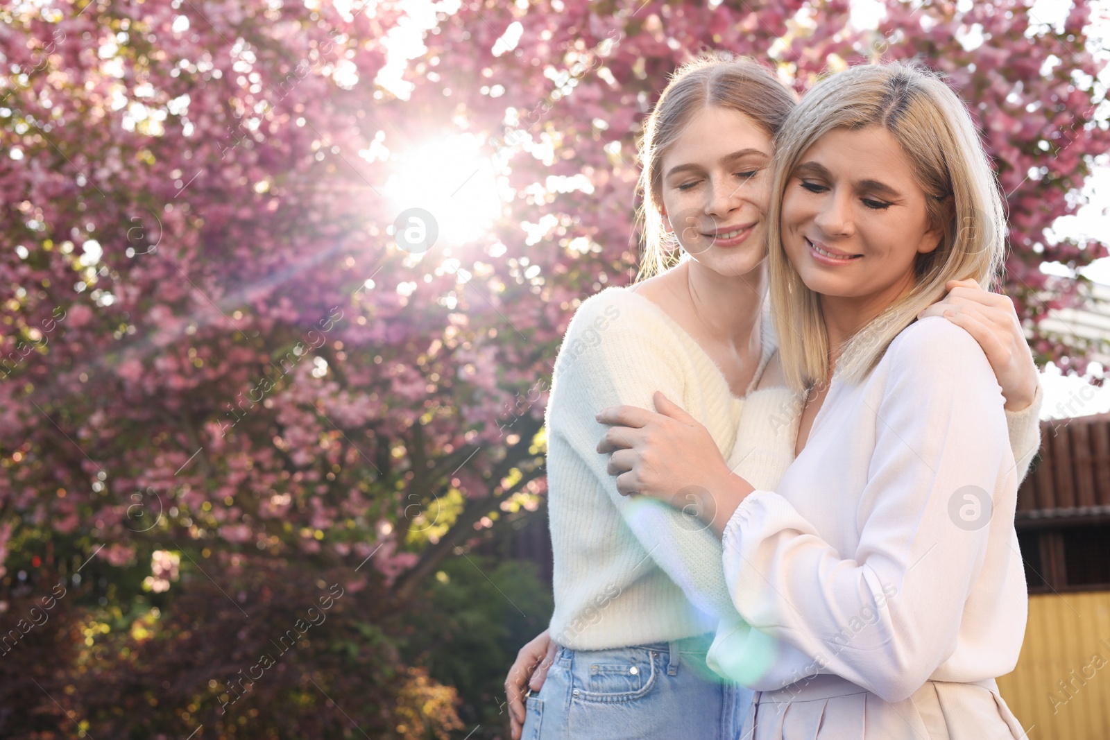 Photo of Happy mother with her daughter spending time together in park on sunny day