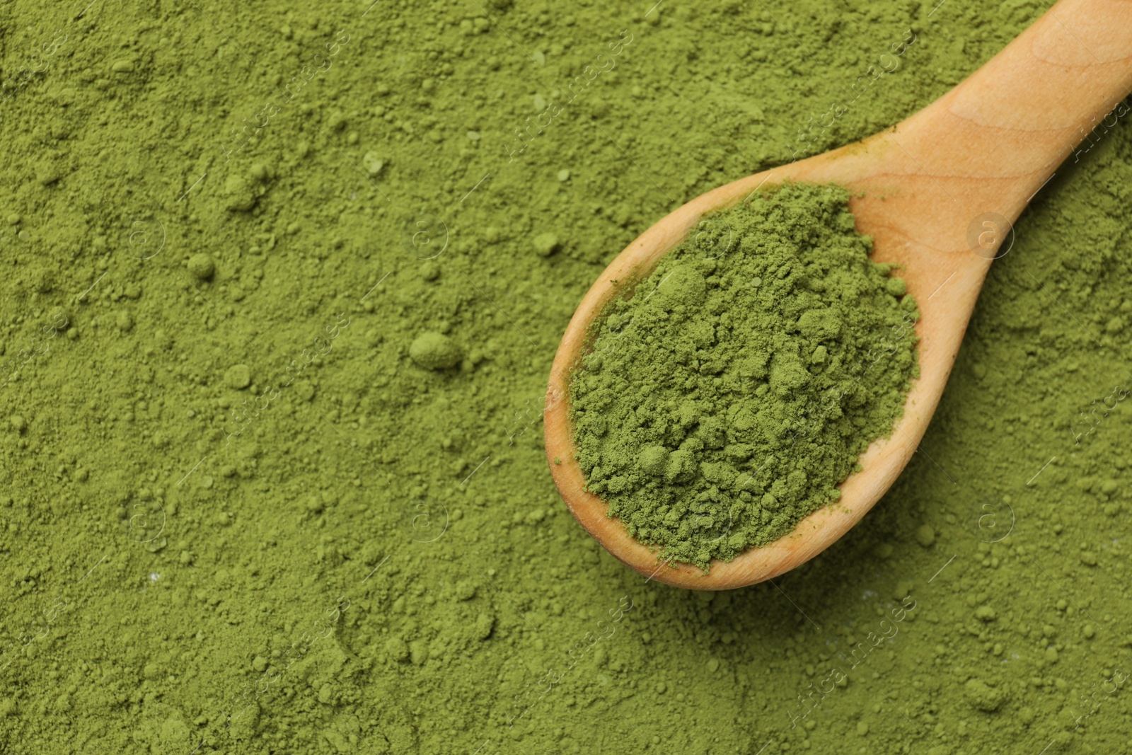 Photo of Spoon and green matcha powder, top view