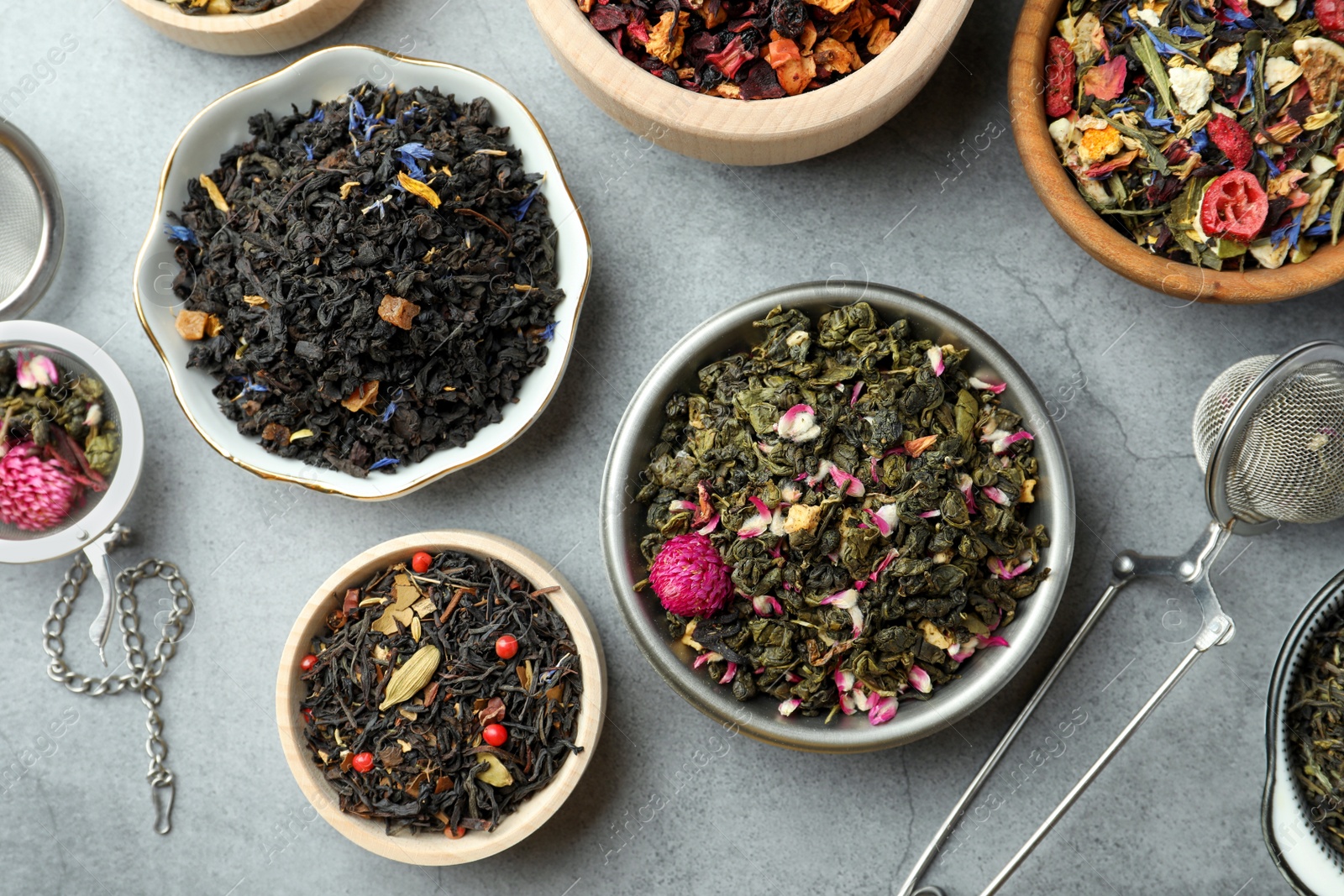 Photo of Many different herbal teas on grey table, flat lay