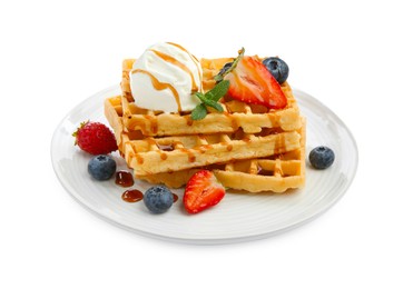 Tasty Belgian waffles with ice cream, berries and caramel syrup on white background