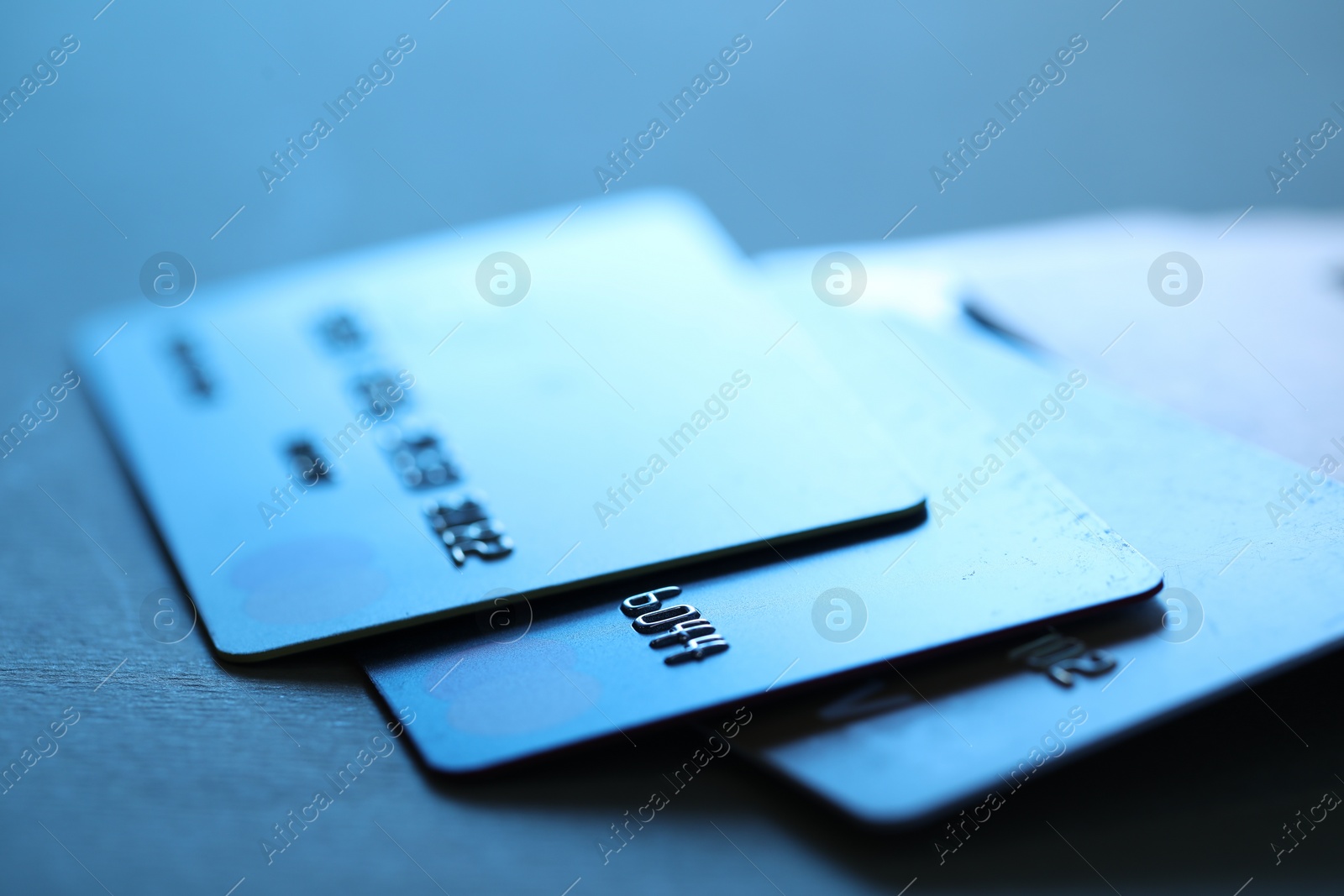 Photo of Many credit cards on dark background, closeup