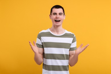 Photo of Portrait of surprised man on orange background