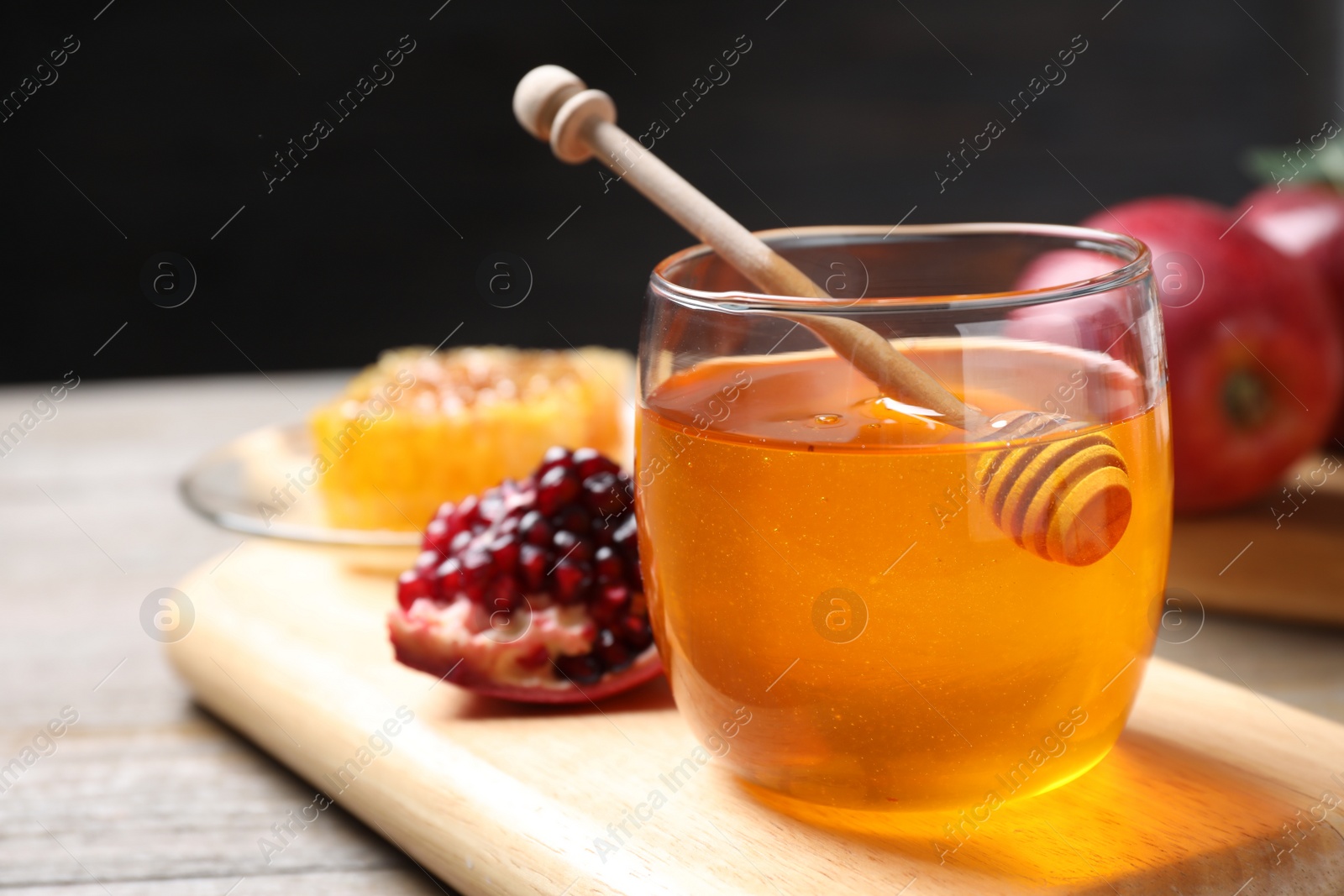 Photo of Honey, apples and pomegranate on table. Rosh Hashanah holiday