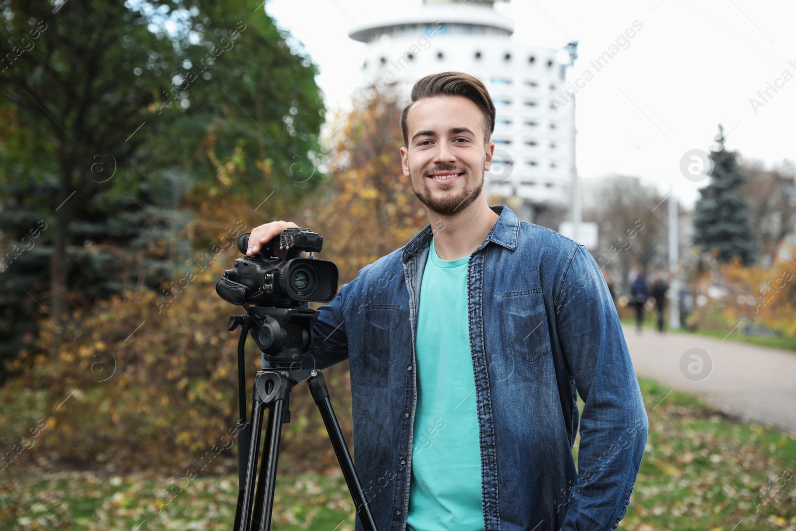 Photo of Video operator with camera working in park