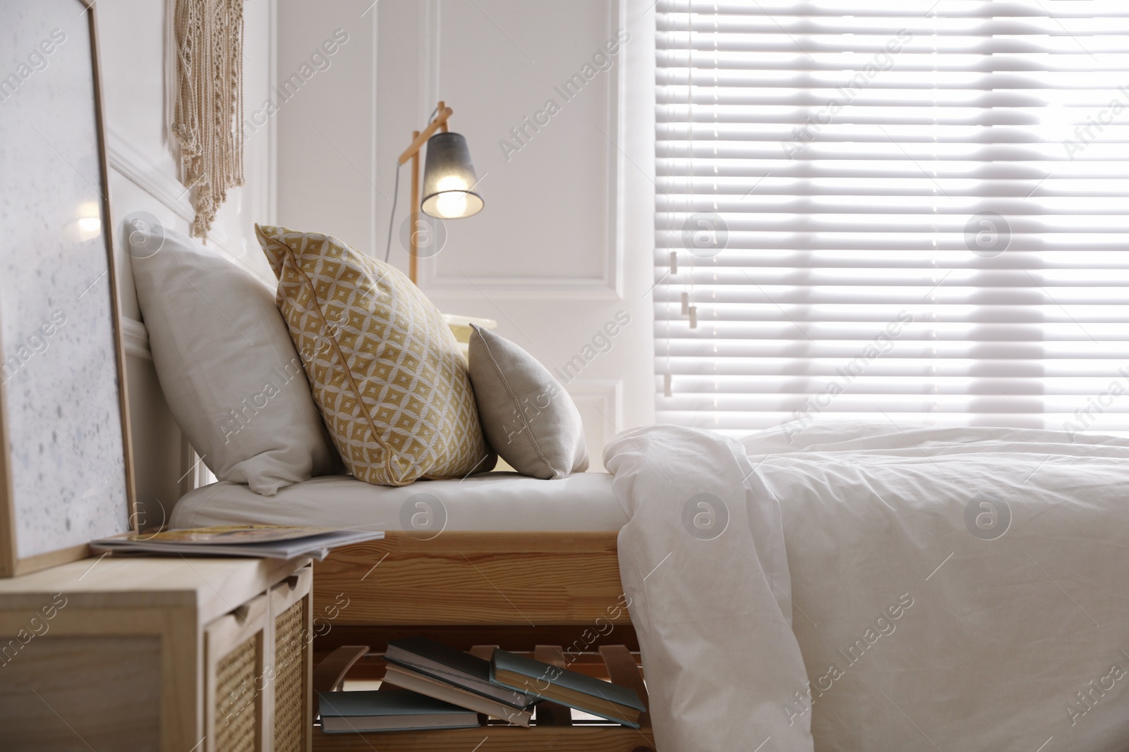 Photo of Comfortable bed with clean white linens indoors