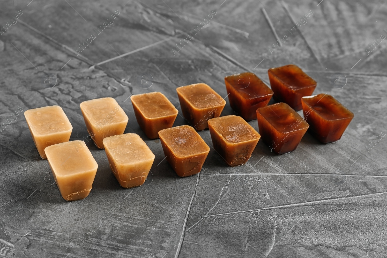 Photo of Composition with coffee ice cubes on grey table