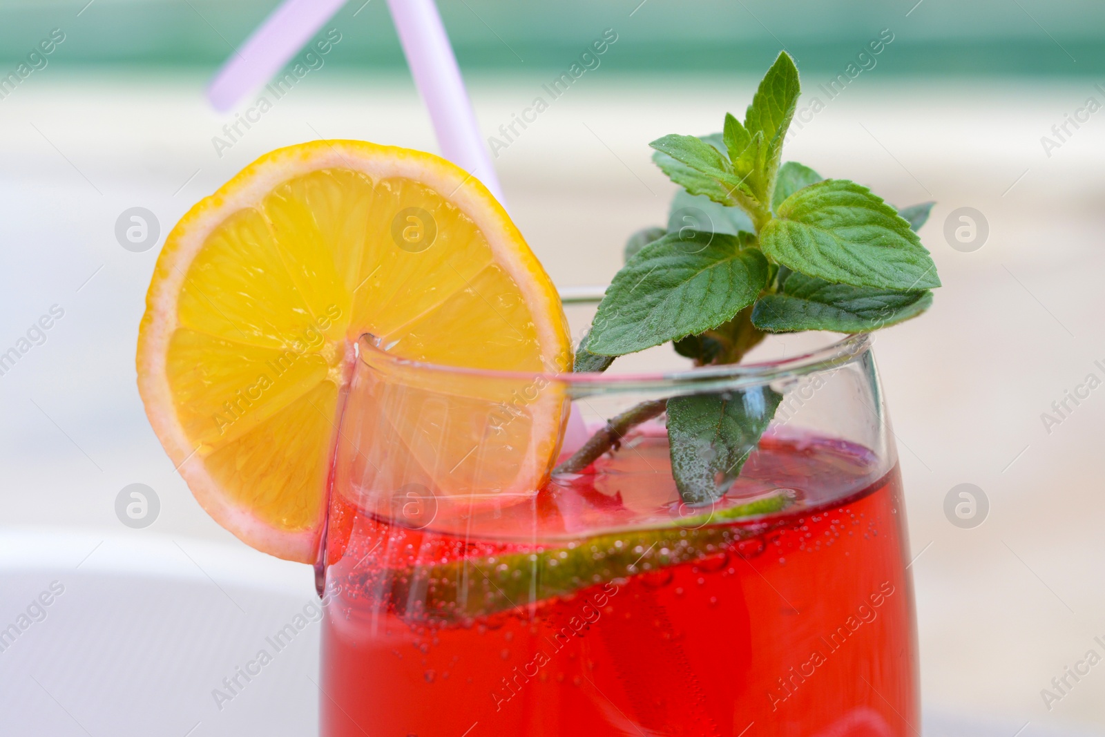 Photo of Glass of delicious cocktail on blurred background, closeup. Refreshing drink