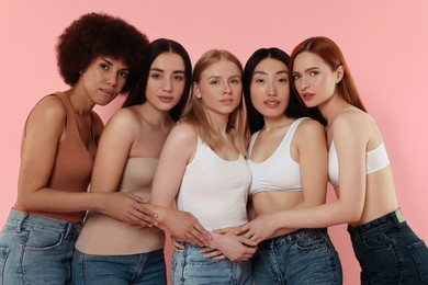 Portrait of beautiful young women on pink background