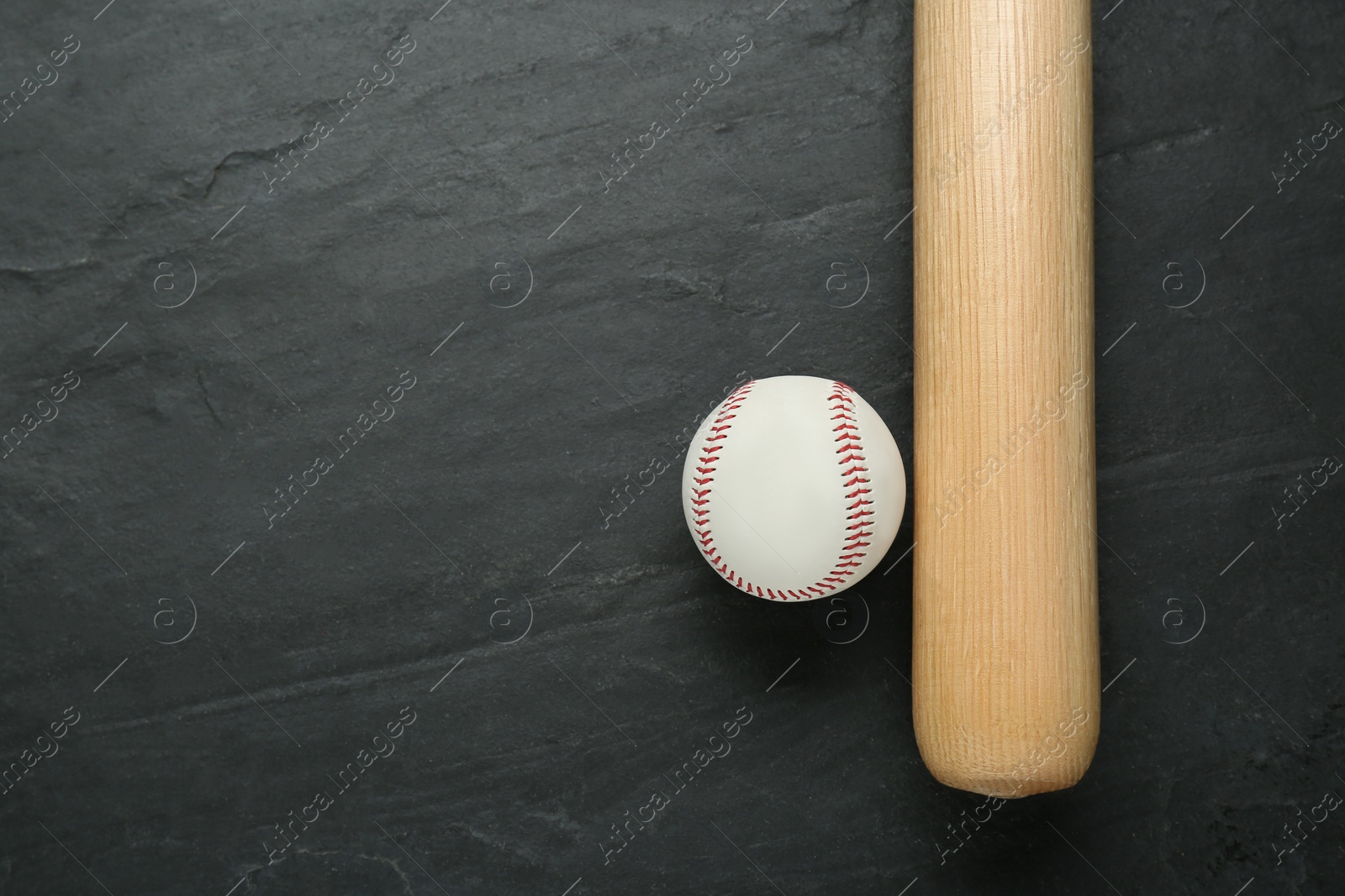 Photo of Baseball bat and ball on black background, top view with space for text. Sports equipment